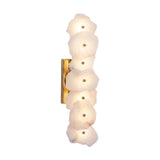 Frammenta LED 7 Light Fragment Alabaster Wall Light in Brass, seven staggered raw-edge alabaster slabs on a rectangular brass backplate, lit, shown on a plain white background.