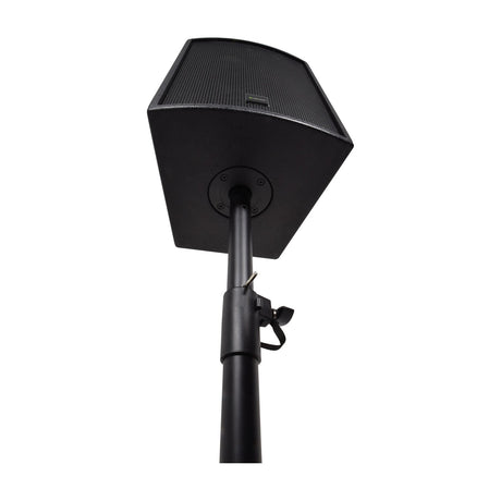 QTX black speaker stand with adjustable steel pole and hand fastener, shown supporting a black PA speaker mounted on top against a white background.