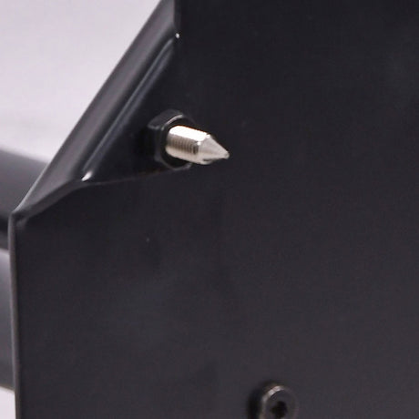 Close-up of a QTX steel studio monitor stand's matt black base corner with a silver floor spike threaded through for stability on any surface.