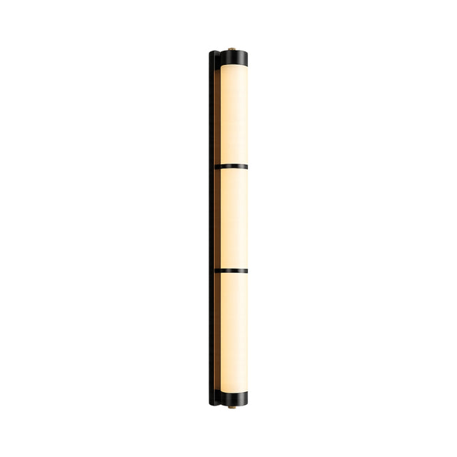 The Arelis LED Linear Alabaster Wall Light in Soft White & Black features a tall, narrow cylindrical shape with a warm beige diffuser and black metal bands, shown on a white background.