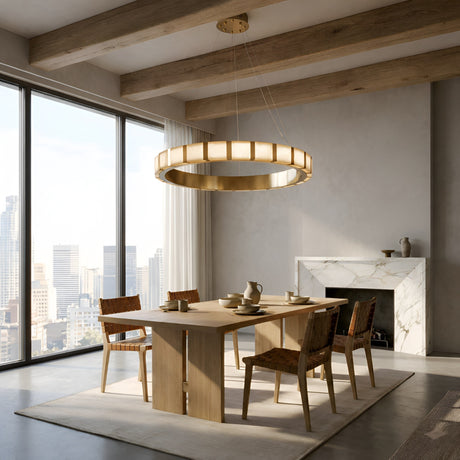 A modern dining room with a wooden table, six woven chairs, ceramic tableware, the Strata LED Small Alabaster Chandelier in Soft White & Copper, floor-to-ceiling windows showing a city skyline, exposed wooden beams, and a marble fireplace.