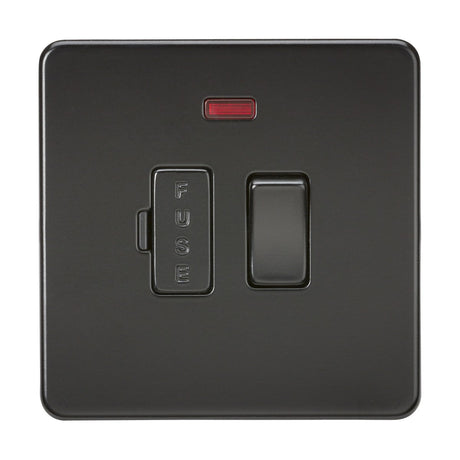 The 13A Switched Fused Spur Unit Neon in a matt black finish has a sleek, screwless low profile design. It features a rectangular red indicator light at the top, a labeled FUSE compartment on the left, and a toggle switch on the right, all of which contrast elegantly against a plain white background.