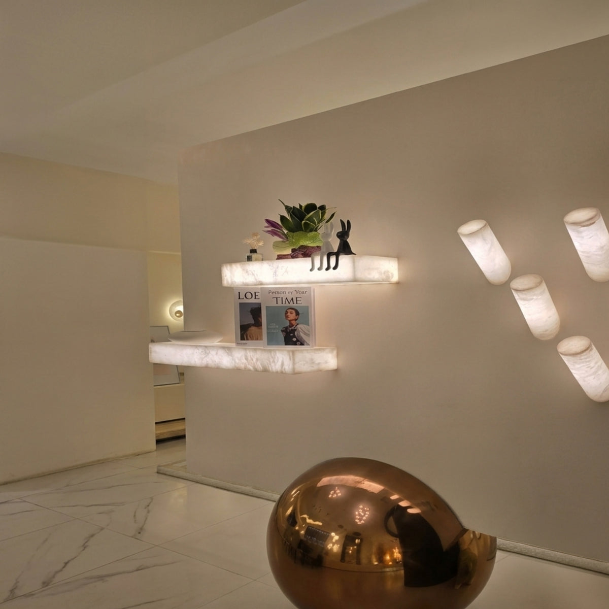 Kate LED Alabaster Wall Shelf Light Small in soft white, illuminated rectangular alabaster ledges mounted on a wall, styled with decor in a home hallway setting.