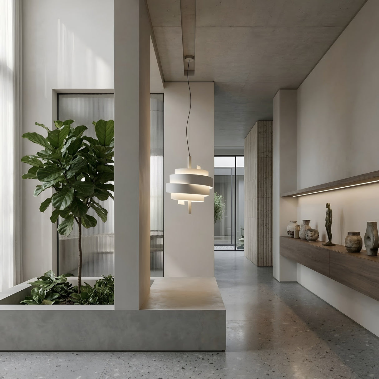 A modern, minimalist interior with concrete floors, a large potted plant, the white Picasso Pendant Light as a sculptural feature, and a wooden shelf displaying vases and sculptures against a neutral wall filled with natural light.