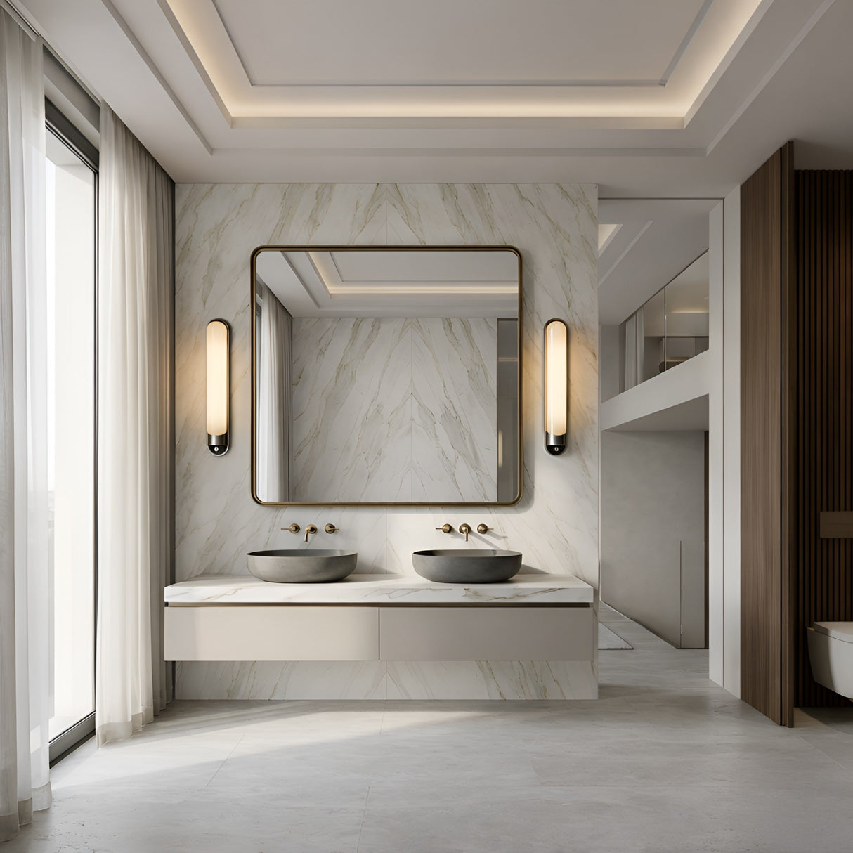 Modern bathroom with a marble accent wall, double gray stone sinks, large mirror, and minimalist lighting, featuring the Lunaris LED Vertical Alabaster Wall Light in Soft White & Black. Sheer curtains let in natural light for an airy atmosphere.