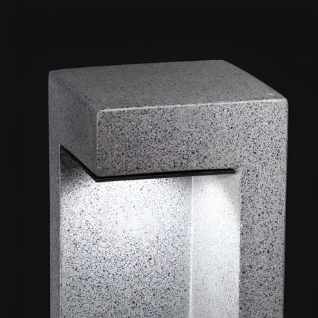 Explore the Starry Outdoor LED Bollard Light, a modern rectangular stone fixture with a textured surface. This weather-resistant and energy-efficient light in grey is 74cm tall, emits a 4000K glow from within, and creates an enchanting outdoor ambiance against a dark background.