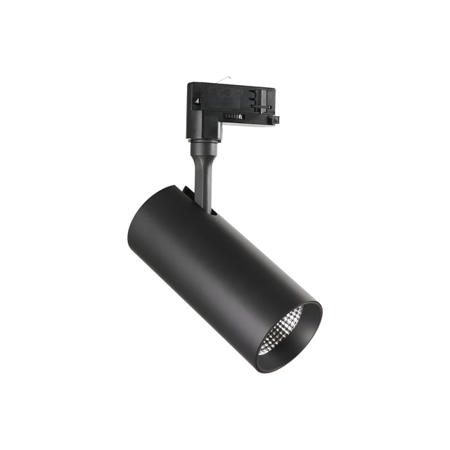 A Pristina LED Three Phase Track Spotlight in black, featuring a cylindrical shape with a sleek modern design. It is angled downward against a white backdrop, showcasing its electrical component at the top. This 30W spotlight serves as accent lighting and offers true-to-life illumination with an impressive CRI of 90 and a beam angle of 24°, emitting a warm 3000K light.