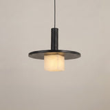 Norevia Cube Alabaster Pendant Light in matte black, featuring a wide disc canopy, slim stem, and glowing alabaster cube shade, shown against a plain light background.
