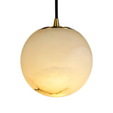 The Lyvane 1 Light Large Globe Alabaster Single Pendant Light in Soft White features a smooth cream alabaster globe shade with a gold cap, hanging from a black cord against a white background.