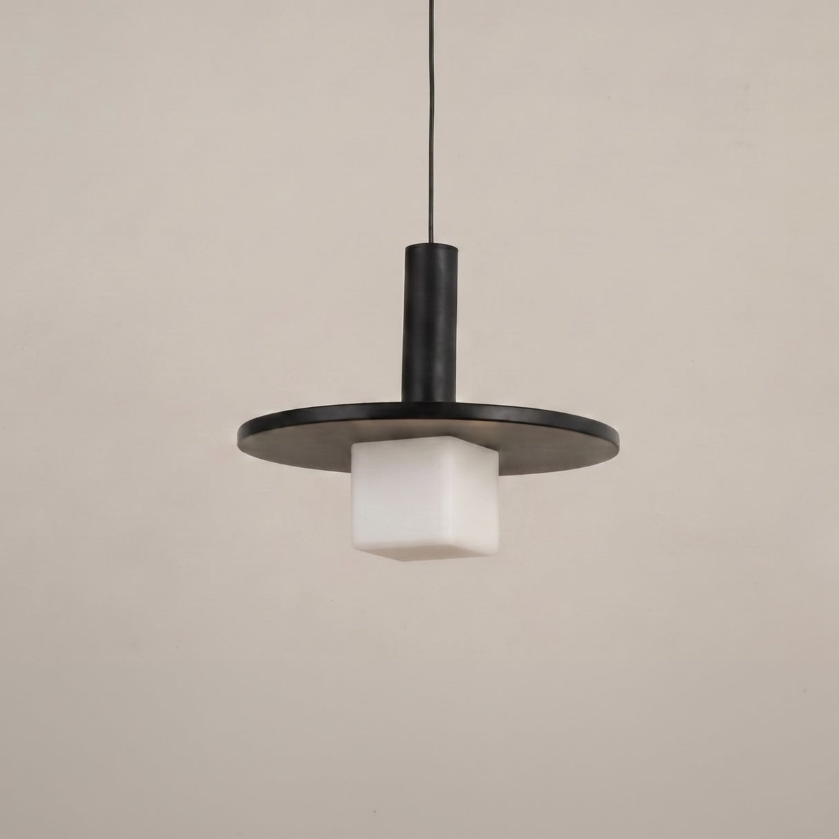 Norevia Cube Alabaster Pendant Light in matte black, featuring a wide flat disc canopy, slim cylindrical stem, and square alabaster glass shade, shown against a plain light background.