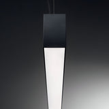 A sleek, modern Sparx Linear LED Suspension Light 27W 3000K with a black casing and white illuminated surface hangs vertically against a dark gradient background, exemplifying energy-efficient lighting.