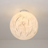The Lunar Flush Ceiling Light - White features a round, frosted glass design with subtle abstract patterns, providing ambient lighting and stylish appeal when installed on any white ceiling.