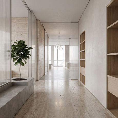 Niori Diverso 3 Light LED Cluster Pendant with clear glass globes hangs at the end of a minimalist hallway with travertine floors and wood shelving.