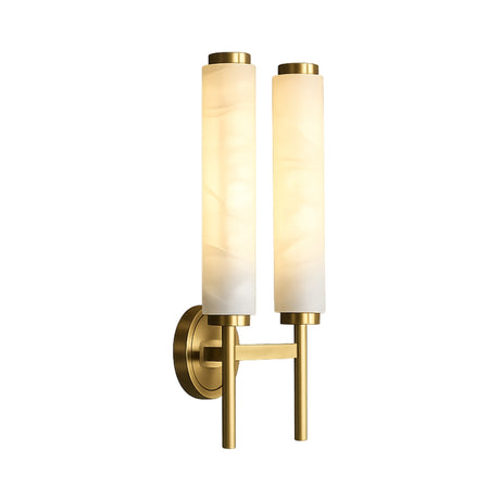 The Noctera LED Twin Column Alabaster Wall Light features two vertical frosted glass cylinders and a brushed brass base on a round backplate, showcased against a white background.