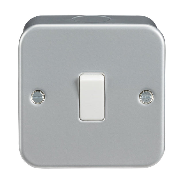 The Metal Clad 10AX 1 Gang 2-Way Switch showcases a premium-grade steel construction with a metallic, square plate featuring rounded corners. It includes a central white toggle switch and two screws on either side, enhanced by its durable powder-coated surface for a sleek design and long-lasting durability.