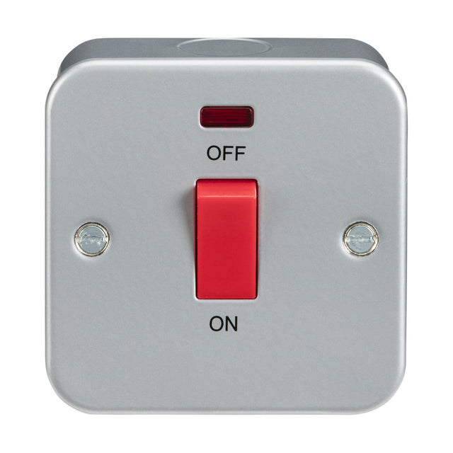 The Metal Clad 45A DP Switch Neon - Single Size is a square, gray electrical switch enclosed in a robust metal-clad box, featuring a striking red toggle. This double pole switch is rated at 45A and allows for ON/OFF operation, with the OFF position at the top and ON at the bottom. Additionally, there is a small neon indicator light located above the toggle.