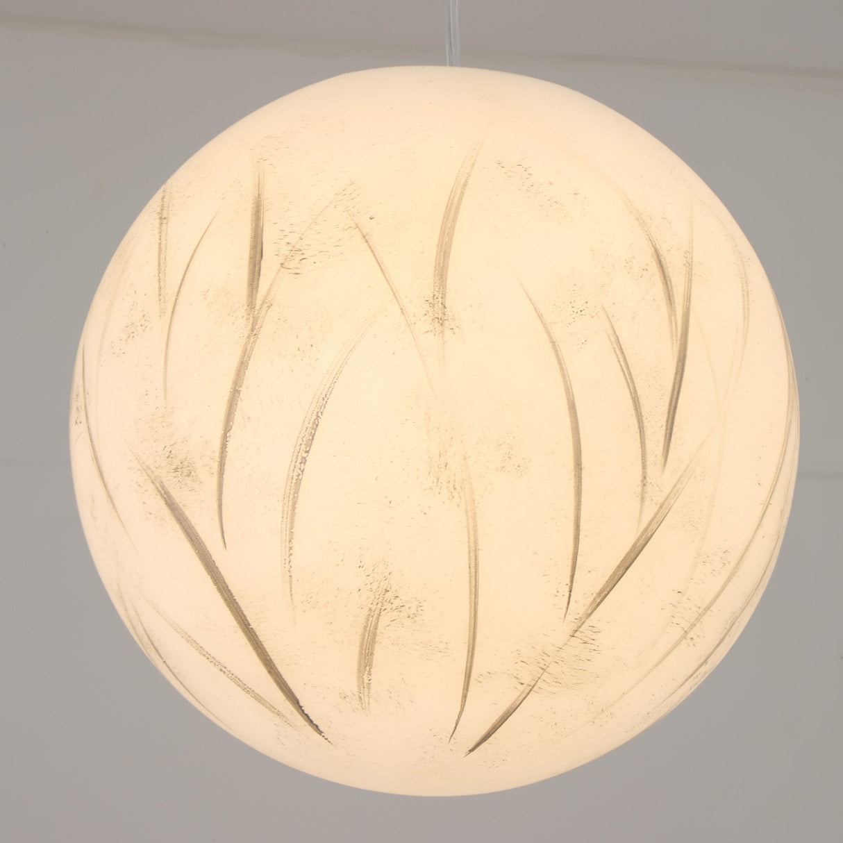 The Lunar Flush Ceiling Light - White features a frosted white surface with subtle leaf-like etchings, providing soft ambient lighting and a modern touch to any room.