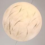 The Lunar Flush Ceiling Light - White features a round frosted glass design with subtle leaf-like patterns, offering hand-painted detail and a soft, warm ambient glow to enhance any space.