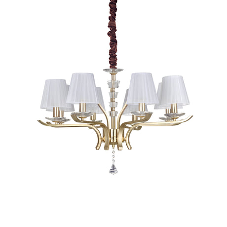 The Solum 8 Light Chandelier - Brass is a luxurious lighting fixture with a satin brass frame, elegantly curved arms, and eight conical white lampshades. It features a decorative chain cover and a central crystal pendant that adds an element of sophistication.