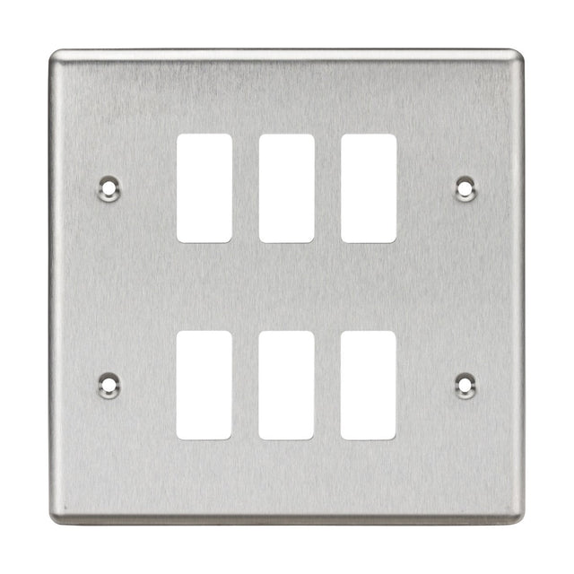 The 6 Gang Grid Faceplate - Rounded Edge Brushed Chrome features six rectangular openings in a layout of two columns and three rows, with four screw holes at the corners for easy mounting. Its brushed chrome finish provides a sleek appearance.