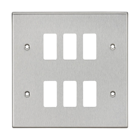 The 6 Gang Grid Faceplate in Brushed Chrome, compatible with the Knightsbridge Grid System, features six rectangular cutouts arranged in two rows of three. It includes four screw holes, one in each corner, for easy mounting and offers a sleek Square Edge Grid Faceplate design.
