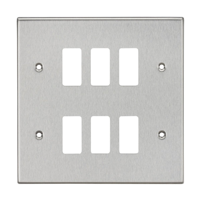 The 6 Gang Grid Faceplate in Brushed Chrome, compatible with the Knightsbridge Grid System, features six rectangular cutouts arranged in two rows of three. It includes four screw holes, one in each corner, for easy mounting and offers a sleek Square Edge Grid Faceplate design.