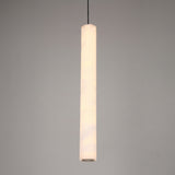 Zenvia LED alabaster single pendant light, slim fluted column with brushed brass cap and black drop cable, warm white glow, plain grey background.