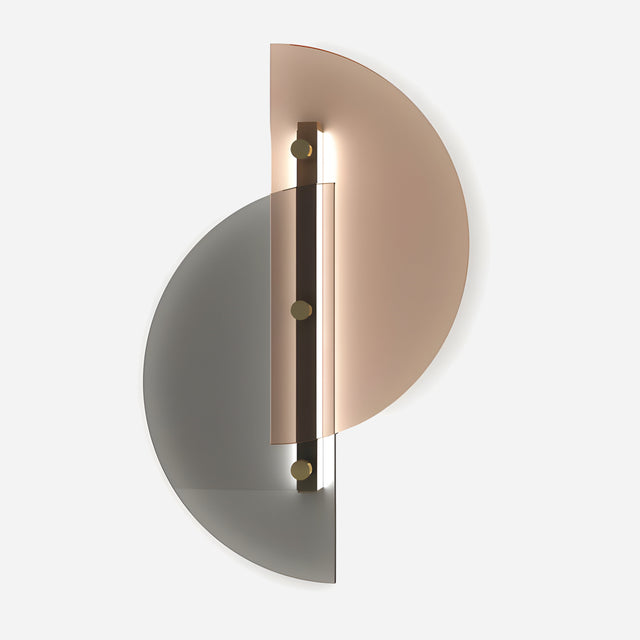 The Papillon LED Wall Light in Silver & Bronze showcases a contemporary design with two overlapping semicircular panels, one silver and the other bronze, highlighted by a central light strip. Its energy-efficient technology enhances its stylish and abstract appearance on a white background.