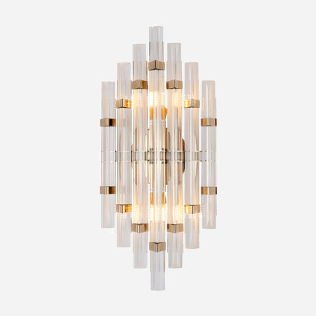 The Magari Crystal Wall Light - Gold & Clear Glass is a contemporary lighting fixture featuring a blend of vertical glass rods and brass accents, with several light bulbs that enhance its sleek and elegant look, beautifully mounted on a white background.