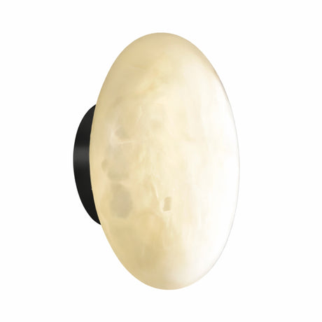 The Solenne LED Small Halo Alabaster Wall Light features a smooth alabaster shade in soft white and a matte black backplate, creating a wall-mounted glow reminiscent of a moon or stone.