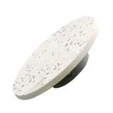Round terrazzo tabletop with a speckled pattern of black, gray, and beige, set on a black metal base. Perfectly complements the ambient halo of the Pin LED Wall Light, embodying modern minimalism.
