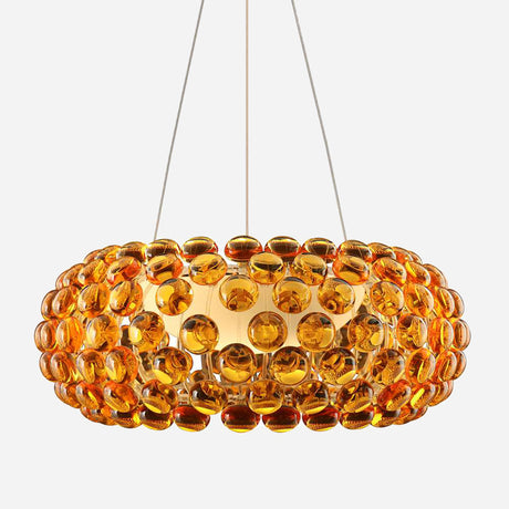 The Briller LED Large Suspension Light in gold boasts a captivating circular design adorned with multiple amber-colored glass orbs. Held up by delicate wires, it emits a warm glow ideal for enhancing any room.