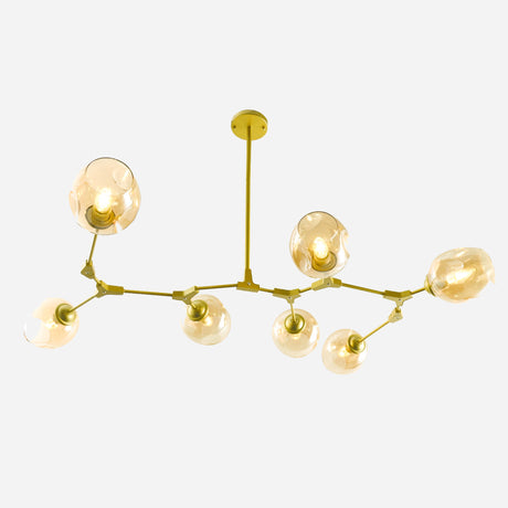 The Tree 7 Globe Suspension Light in Gold features a contemporary chandelier design with a gold metal frame and seven amber glass globe light fixtures, elegantly suspended from the ceiling against a white background.