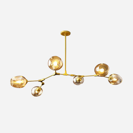 The Tree 6 Light Suspension in gold is a modern chandelier showcasing an asymmetrical design with branches extending in various directions. It features six spherical glass fixtures that hold translucent orbs against a plain backdrop, making it an elegant lighting fixture for any space.