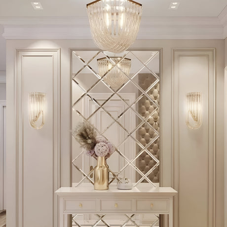 The elegant hallway interior exudes vintage opulence, with mirrored wall panels reflecting light from the Murano 6 Light Crystal Chandelier - Gold and matching wall sconces. A decorative console table with a gold vase, dried flowers, and a small ornament in gold finish adds a touch of sophistication.