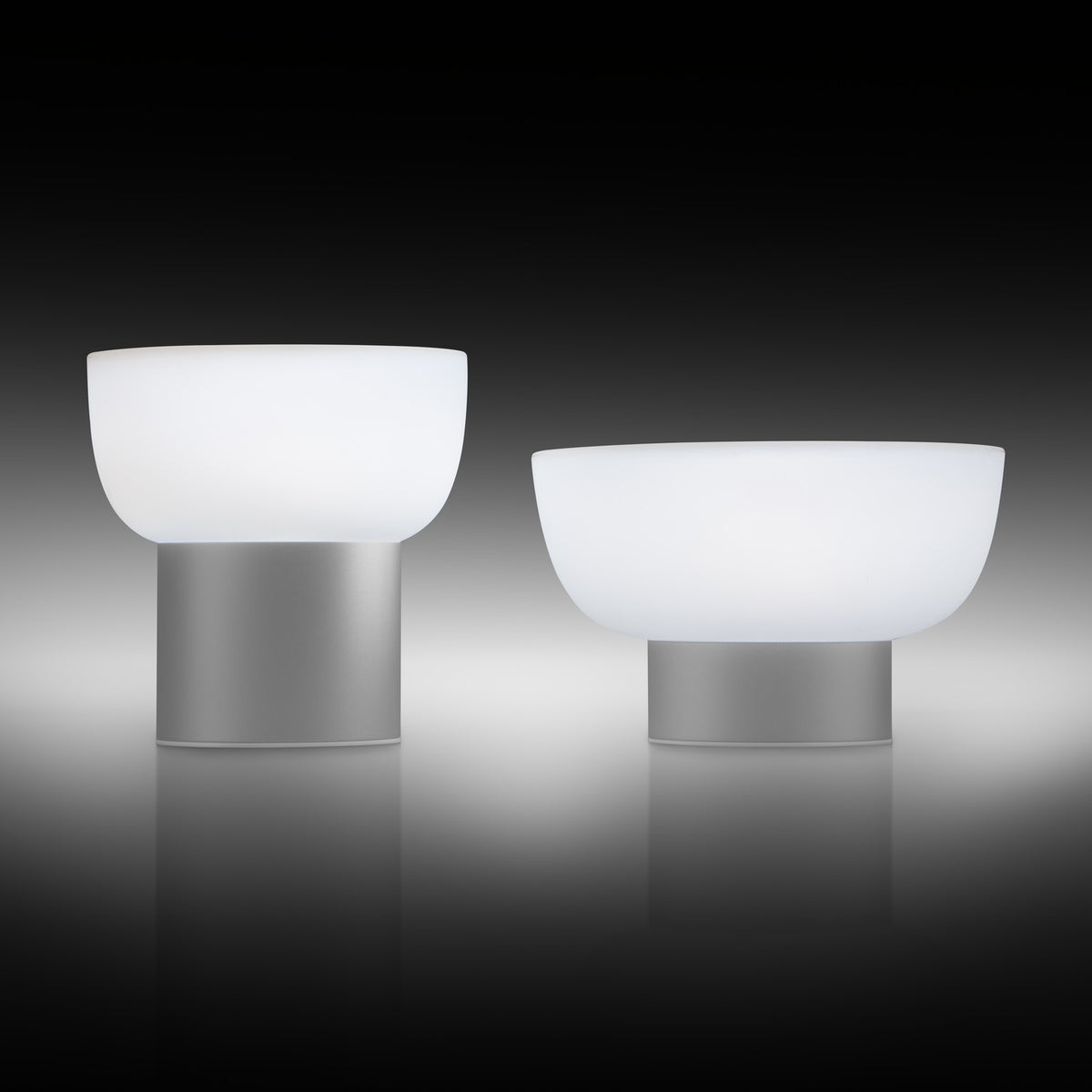 Patio LED Rechargeable Outdoor Table Lamp in silver, two sizes shown with rounded opal shades on slim cylindrical bases, set against a dark background.