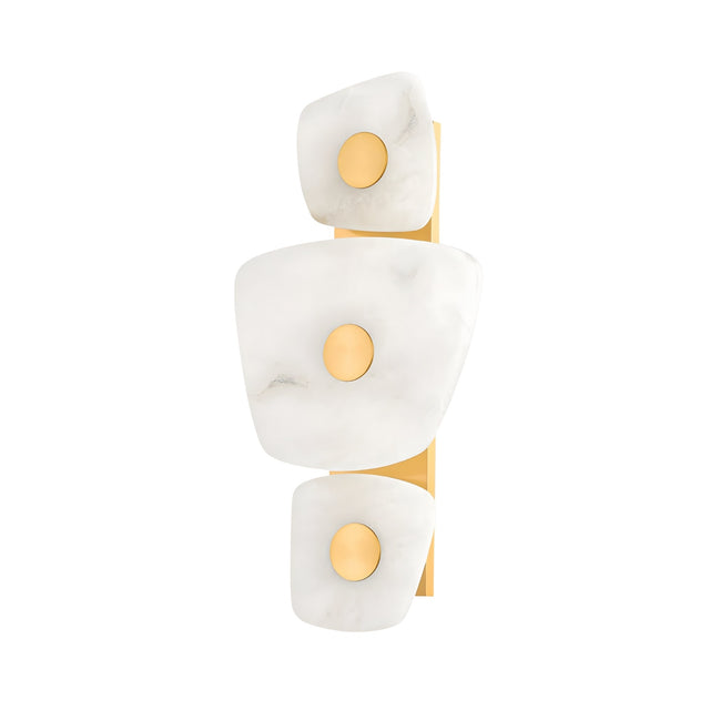 The Calyra LED Alabaster Wall Light features three irregular soft white Spanish alabaster panels with central gold accents, all mounted on a sleek vertical brass backplate for a modern look.