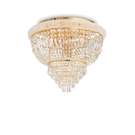 The Emberlit 6 Light Crystal Chandelier - Brass showcases a luxurious design with a brass finish and gold base, presenting multiple tiers of sparkling teardrop-shaped crystals. This elegant piece also features dimmable functionality, amplifying its opulent charm.