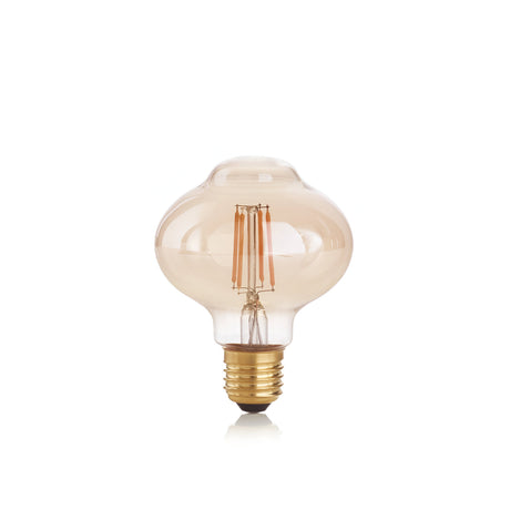 Discover the vintage allure of the 4W Non-Dimmable LED Bolla Filament Bulb, Amber, E27, 1800K. With its decorative design and energy-efficient technology, this bulb emits a warm glow through its round shape and brass-colored screw base. Its tinted glass enhances the antique aesthetic beautifully.