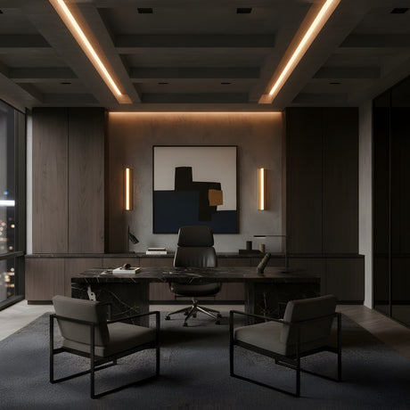 A modern, dimly lit office with a sleek black desk, leather chair, guest chairs, abstract wall art, Elvaris LED Large Vertical Alabaster Wall Light in brushed brass & soft white, and floor-to-ceiling windows overlooking a city at night.