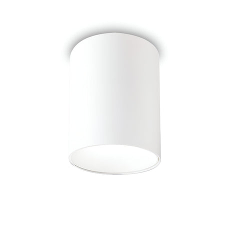 A white cylindrical ceiling light fixture is mounted on a plain, white ceiling, providing an energy-efficient lighting solution. This Lucent LED Round Downlight 25W 3000K - White, 9cm features a smooth, minimalist design with light gently diffusing around the edges, making it ideal for contemporary interiors.