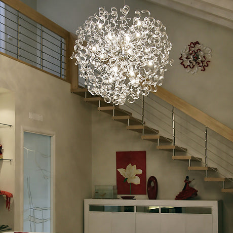 Astro 18 Light Crystal Chandelier with clear curled glass elements and chrome fittings, hung above a staircase in a bright open hallway.