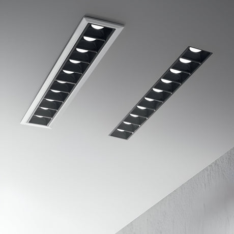 The ceiling boasts two Phosix Trimless LED Recessed Downlights, each with a power of 20W and a color temperature of 3000K in a sleek black finish. These fixtures deliver a modern, minimalist appearance that elevates the room's streamlined design. Their seamless installation and die-cast aluminum craftsmanship harmonize flawlessly with the neutral hues of the ceiling and walls.