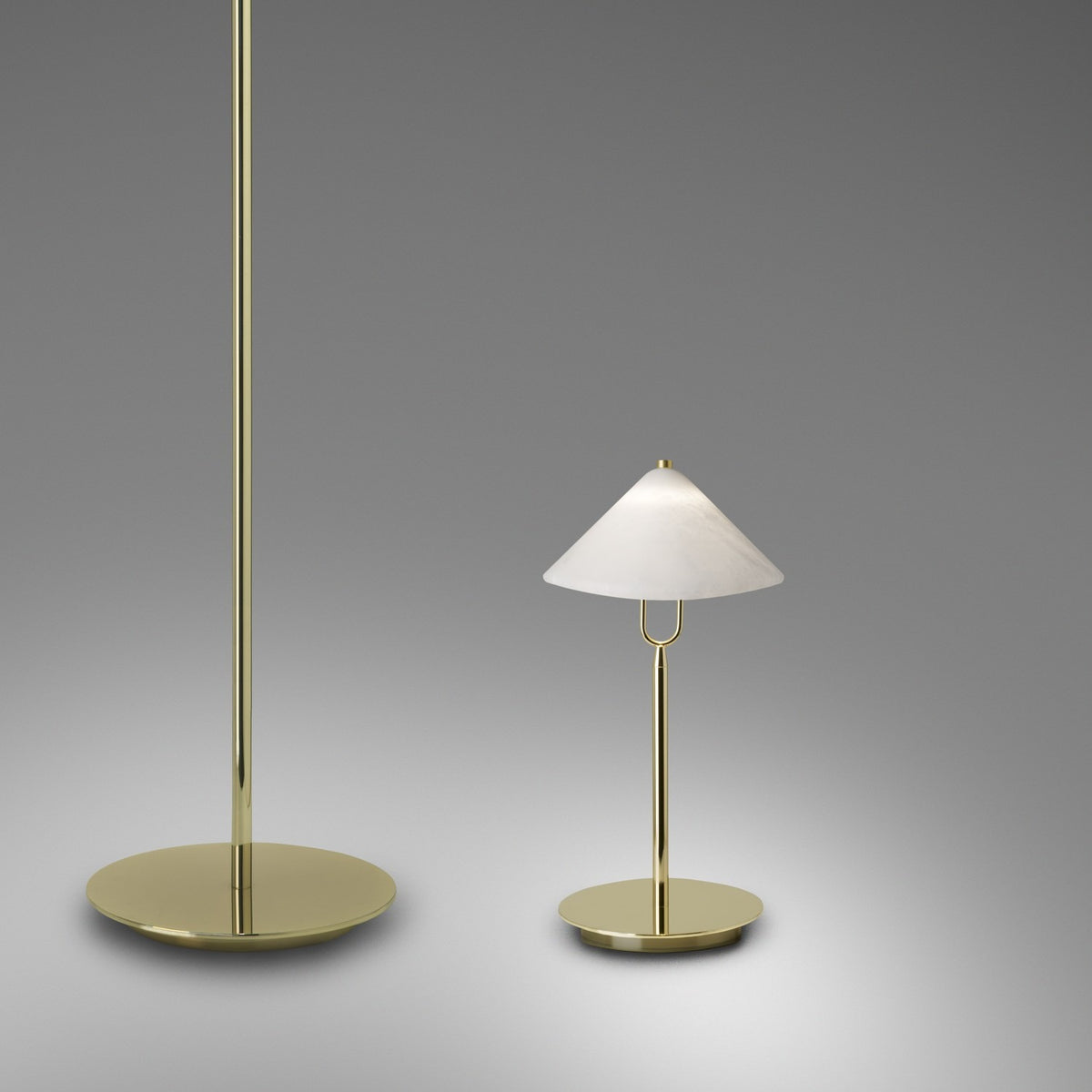 Fuji LED Alabaster Table Lamp in polished brass with a conical alabaster shade and round disc base, shown beside a matching floor lamp on a grey background.