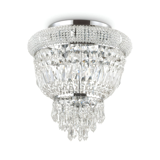 Introducing the Emberlit 3 Light Crystal Chandelier - Chrome, a luxurious crystal centerpiece featuring multiple tiers of sparkling, hanging prisms and a polished metal base. Designed for ceiling installation, this dimmable lighting fixture exudes elegance with its intricate details and reflective surfaces.