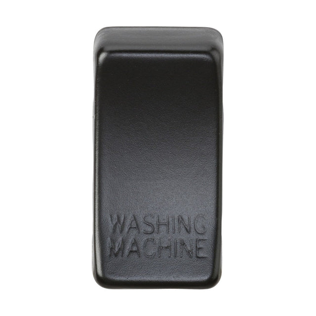 Introducing the Switch Cover "Marked WASHING MACHINE" in a sleek matt black finish, this rectangular button is crafted from plastic with rounded edges and features embossed text that reads "WASHING MACHINE," reminiscent of rocker covers.