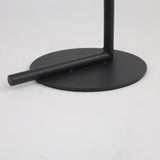 A close-up of the Vetra 1 Light Opal Glass Floor Lamp in black, showing its matte circular base with vertical and horizontal rods, designed for modern spaces, set against a plain white background.