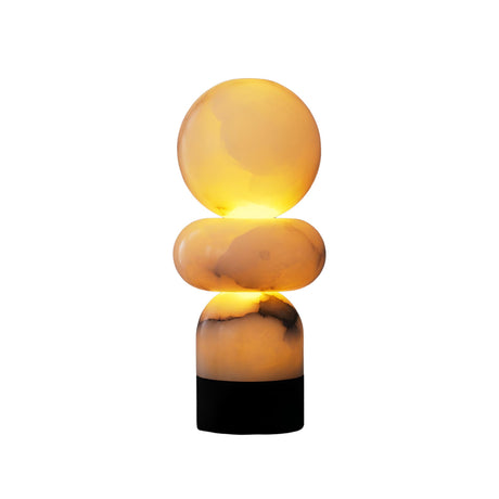 The Talmera 1 Light Small Sculptural Sphere Alabaster Table Lamp features a glowing sphere top and sculpted base in soft white and black, shown against a plain white background.
