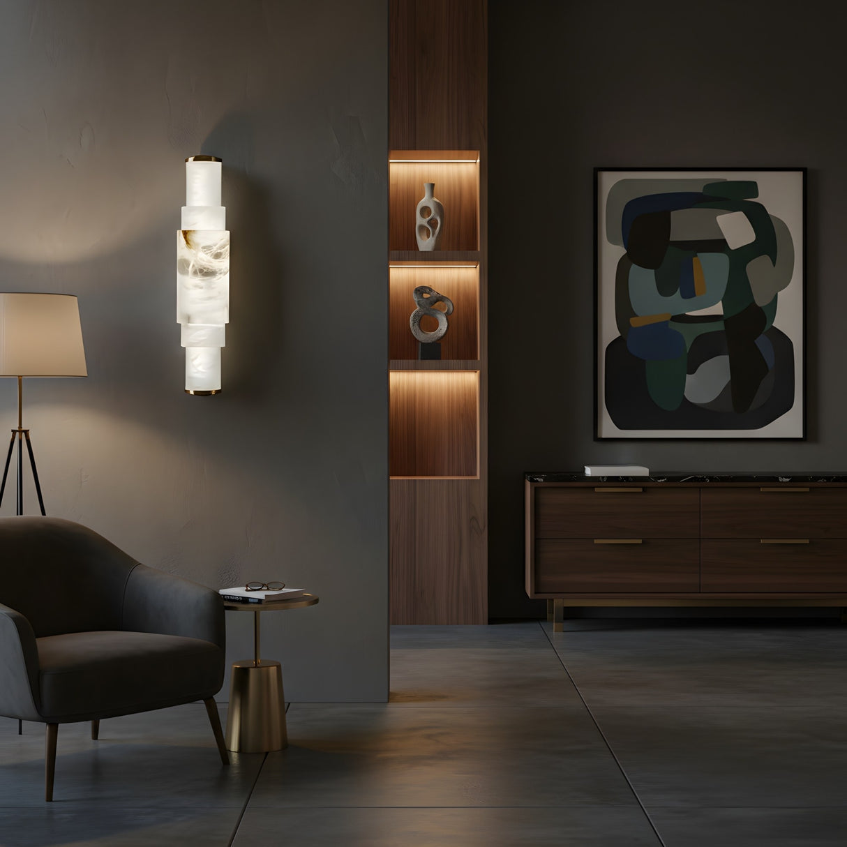 A modern living room with dark walls, abstract art, gray armchair, brass side table, and wooden cabinet features decorative objects illuminated by the Aurelia LED Alabaster Wall Light – Soft White for a soft ambiance.