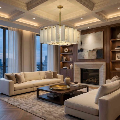 A modern living room with two beige sofas, a wooden coffee table, the Lunaro 20 Light Tiered Panel Alabaster Chandelier in brushed brass and soft white for striking lighting, a large abstract painting above the fireplace, built-ins, and a city view at dusk.